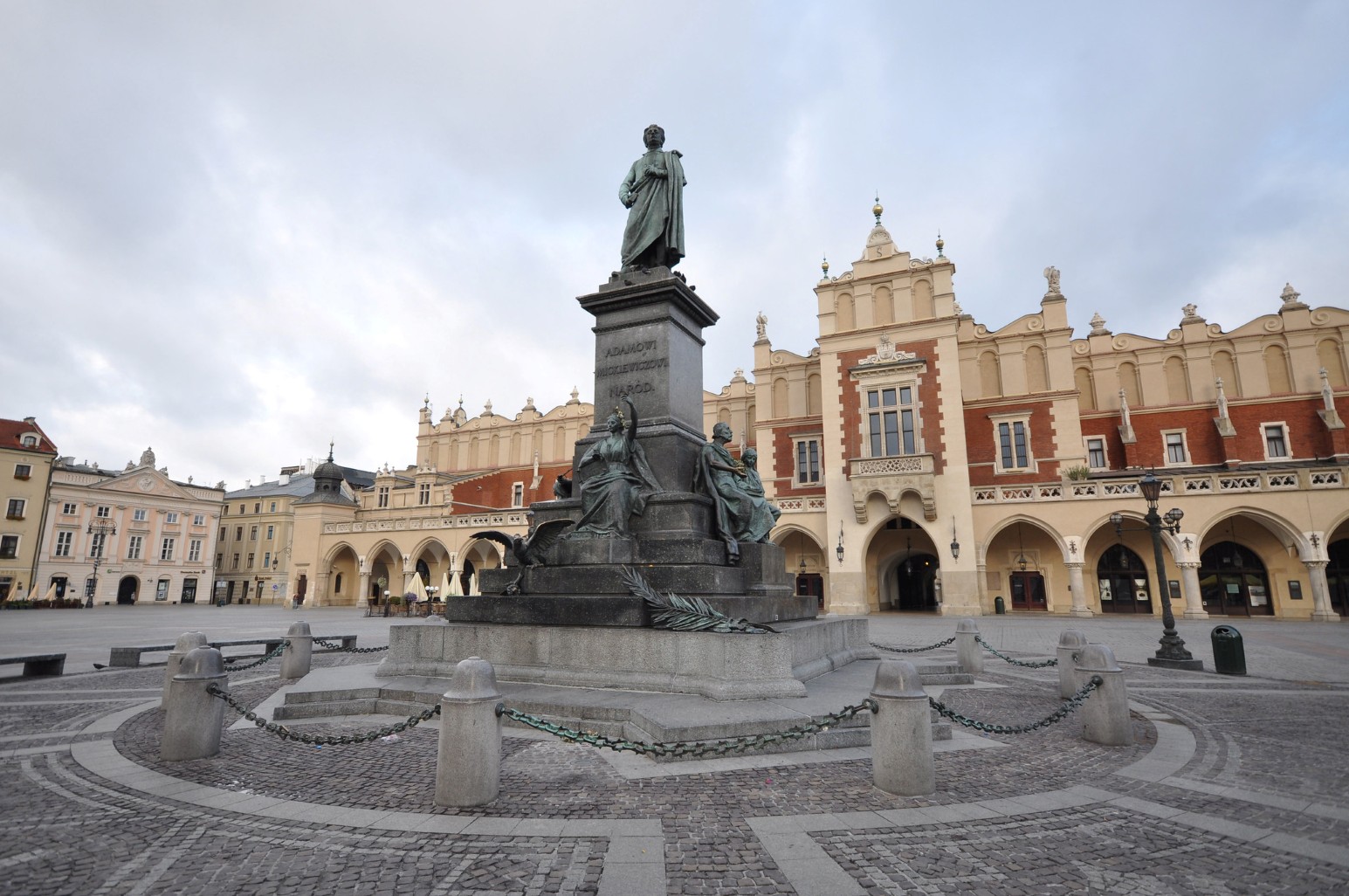 The Adam Mickiewicz monument in Kraków's Main Market Square, with the Renaissance-era Cloth Hall visible in the background.