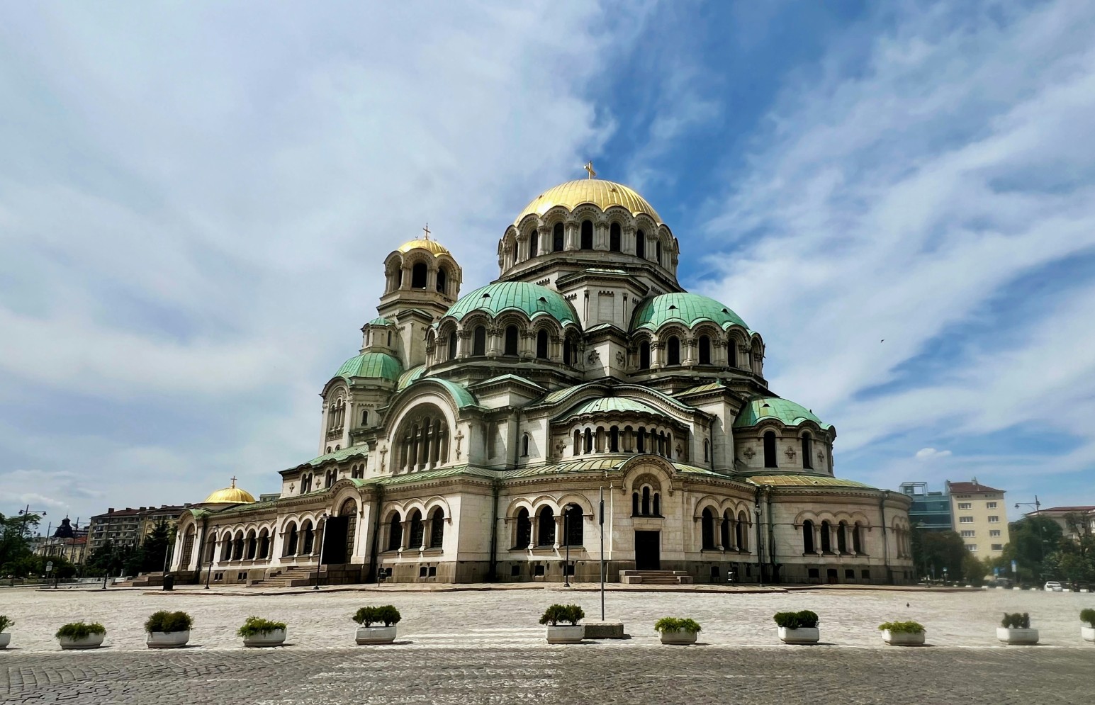 Alexander Nevsky Cathedral in Sofia, its gold and green domes set against a bright blue sky