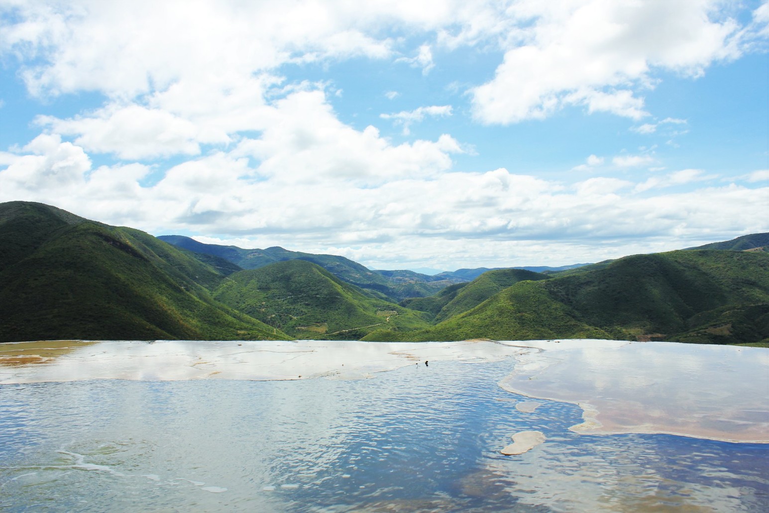 The mineral pools at Hierve el Agua in Oaxaca, looking out over green hills and a wide valley