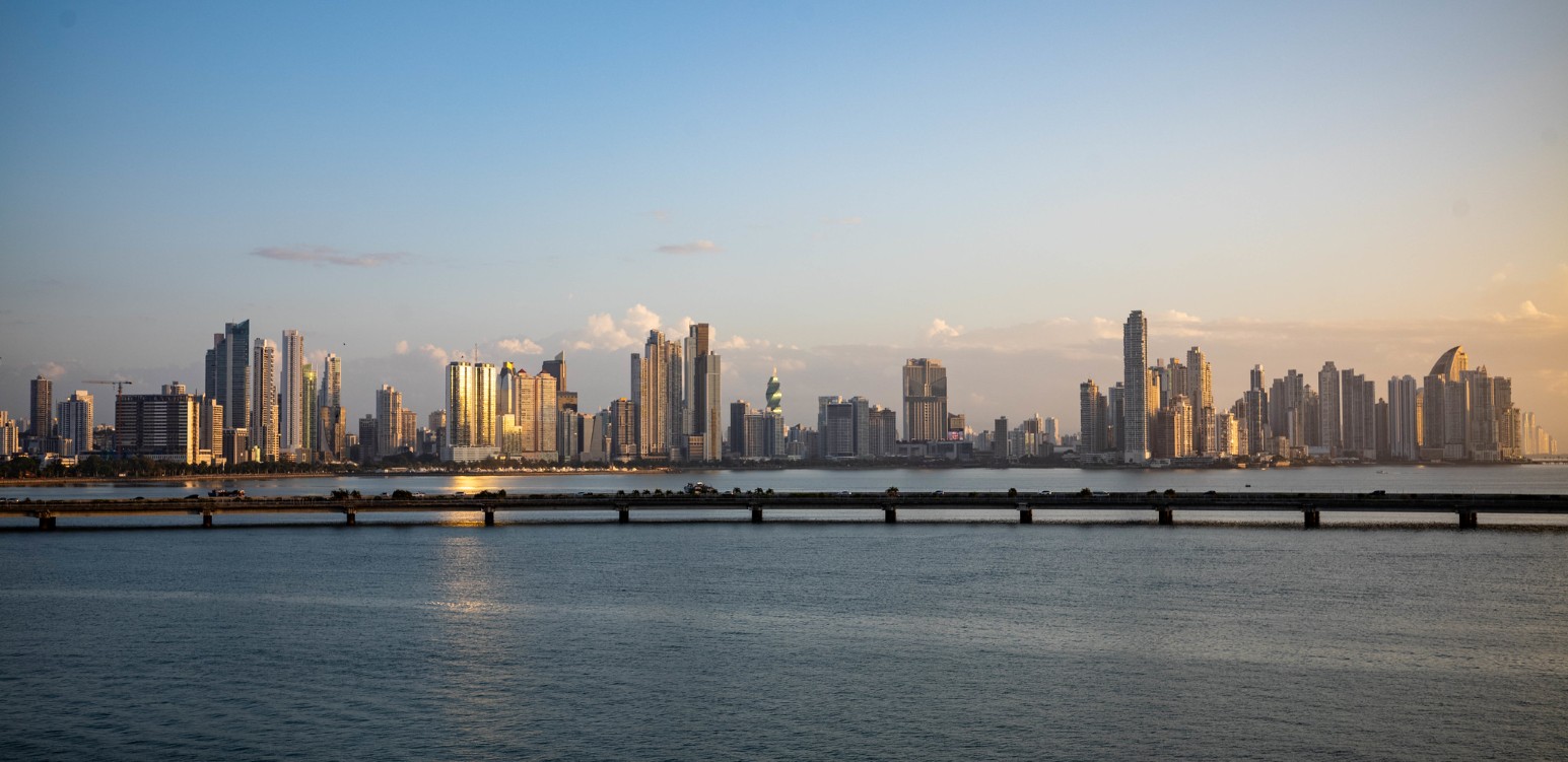 The Panama City skyline of high-rise towers seen across the bay at sunset